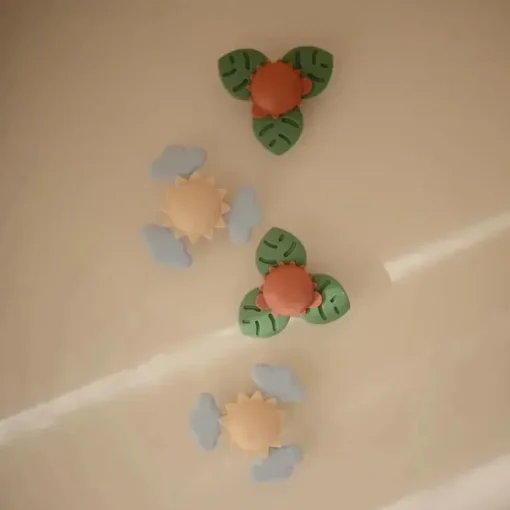 Mushie - brinquedo giratório de sucção Dino para banho e brincadeira