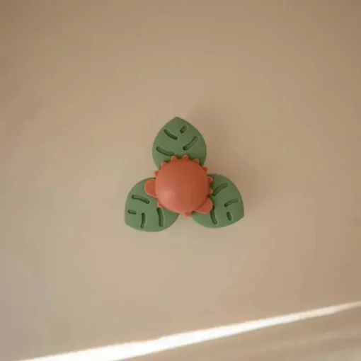 Mushie - brinquedo giratório de sucção Dino para banho e brincadeira