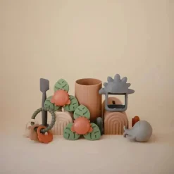 Mushie - brinquedo giratório de sucção Dino para banho e brincadeira