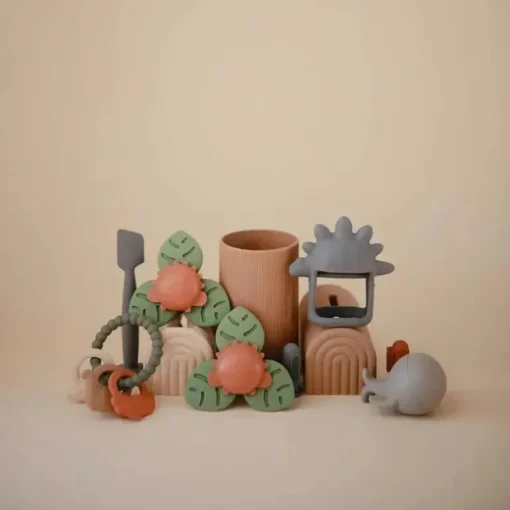 Mushie - brinquedo giratório de sucção Dino para banho e brincadeira