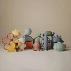 Mushie - Brinquedo mordedor de silicone para bebê com chocalho de foguete