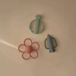 Mushie - Brinquedo mordedor de silicone para bebê com chocalho de foguete